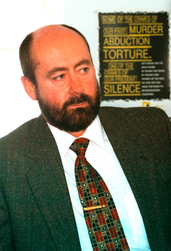 Dr Wouter Basson in front of South African TRC poster. Photograph by Eric Miller